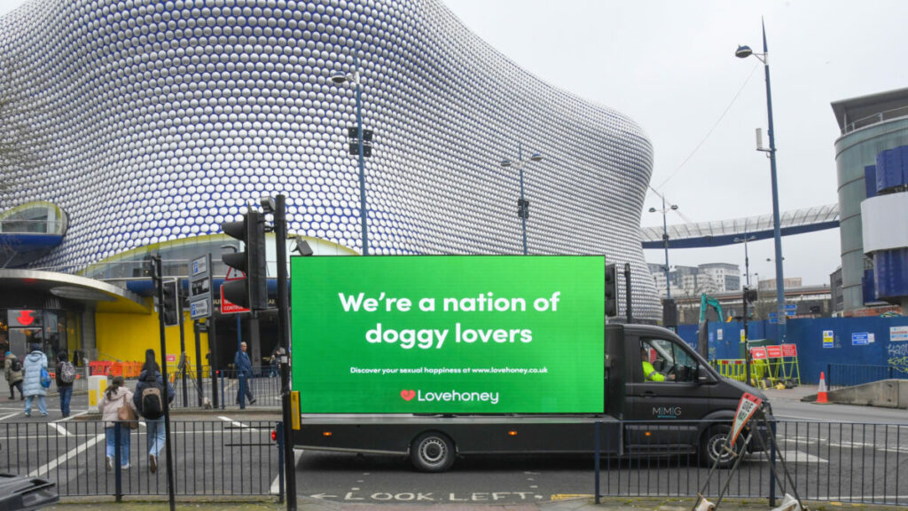Lovehoney billboard on van in Birmingham which read "We're a nation of doggy lovers. Celebrate your sexual happiness at www. lovehoney.co.uk" Lovehoney has created a risqué new billboard celebrating the fact that the UK is "a nation of doggy lovers", coinciding with the dog show Crufts.