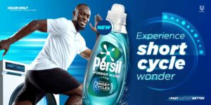 Unilever brand Dirt Is Good is starring Usain Bolt in a multi-million pound marketing campaign to support the launch of its new Persil Wonder Wash product. The image shows Usain Bolt preparing to sprint on a green background with the phrase "Experience Short Cycle Wonder". Behind him is a laundry that reads "Short Cycle" on the settings screen. In the left hand corner is the phrase "Usain Bolt the world's fastest man"